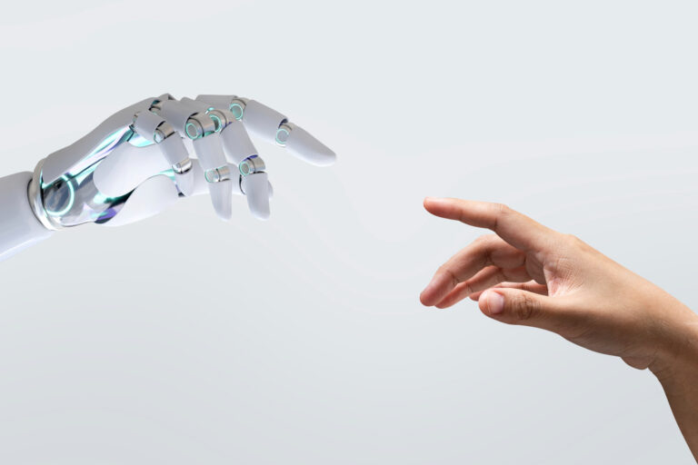 A robotic hand and a human hand reach toward each other